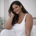 Plus size model sitting wearing white stretch camisole, soft breathable cotton lycra fabric