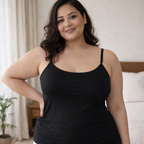 Plus size woman wearing a black cotton lycra camisole with thin straps, front view, soft indoor setting